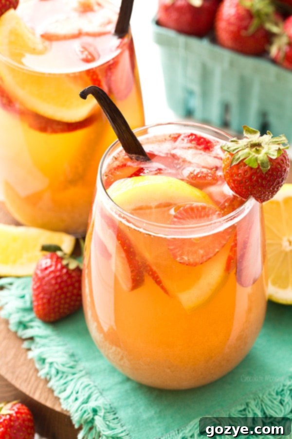 Refreshing Strawberry Vanilla Sangria in a glass with fresh fruit, perfect for summer.
