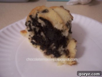 Delicious Oreo Bundt Cake, freshly baked with a rich chocolate and cream filling visible.