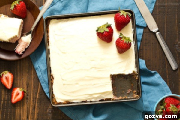 Strawberry Snack Cake baked in an 8x8 pan with a slice removed, ready to serve