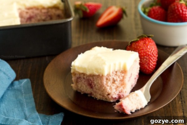 A beautifully cut slice of Strawberry Snacking Cake on a white plate