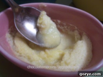 Two Lemon Pudding Souffles in white ramekins, showing the golden souffle top and the slightly liquidy pudding layer beneath.