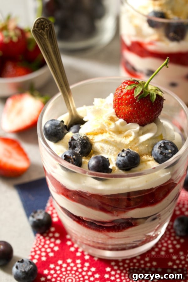 No Bake Cheesecake Cups with fresh strawberries and blueberries, ready to be enjoyed as a refreshing summer dessert.