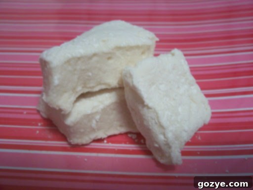 Platter of freshly cut, square homemade marshmallows dusted with cornstarch.