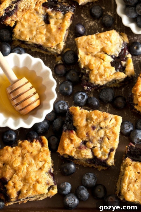 Soft, moist, and reminiscent of oatmeal cookies, Honey Blueberry Oatmeal Bars are filled with a homemade blueberry honey jam without pectin.