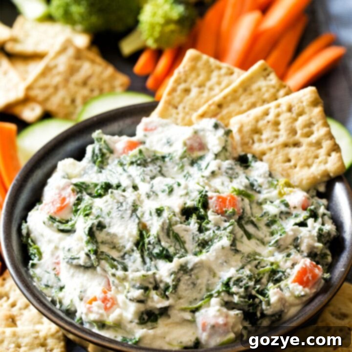 Ranch Spinach Dip in black bowl with crackers