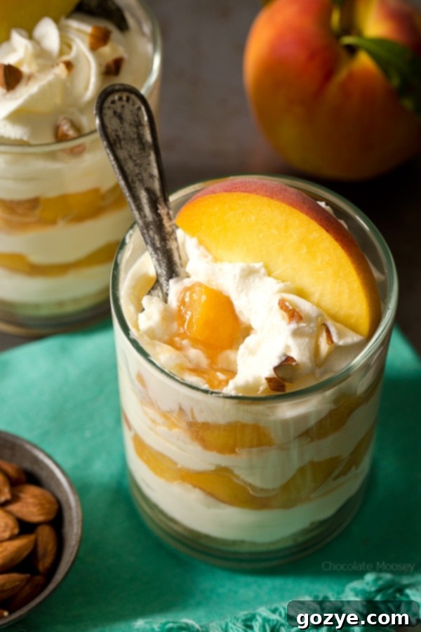 Peaches and cream cheese dessert layered as cheesecake parfaits, showing the beautiful presentation in glasses.