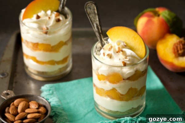 No Bake Cheesecake with Peaches in parfait glasses, ready to be served.