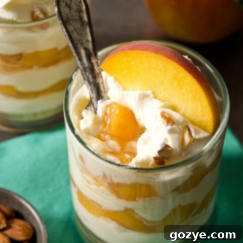Peaches and cream cheese dessert layered as cheesecake parfaits