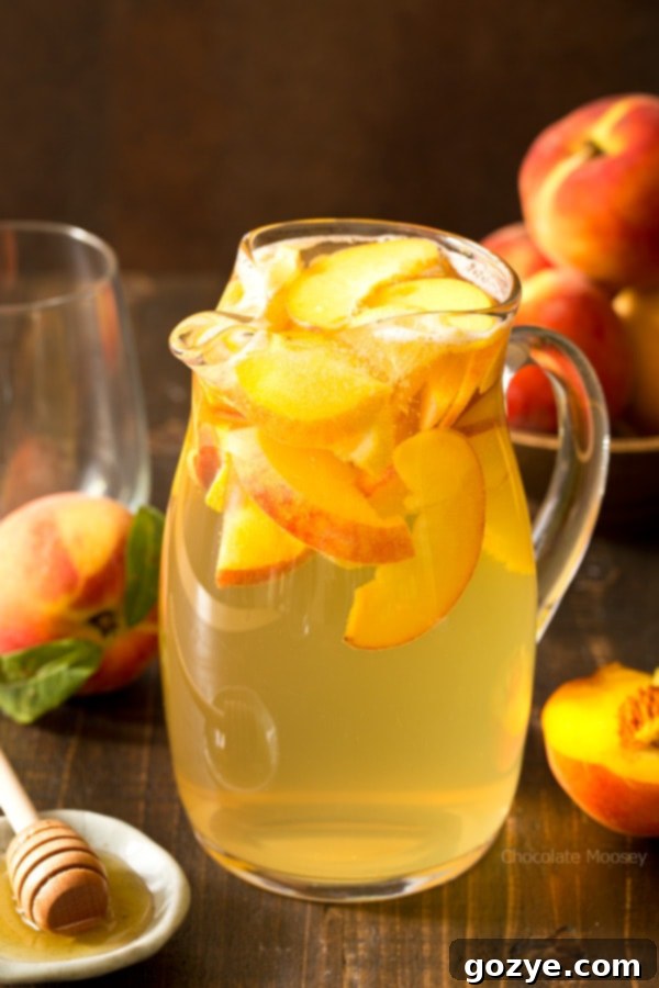 Slicing fresh peaches for a homemade Peach Honey Sangria recipe.