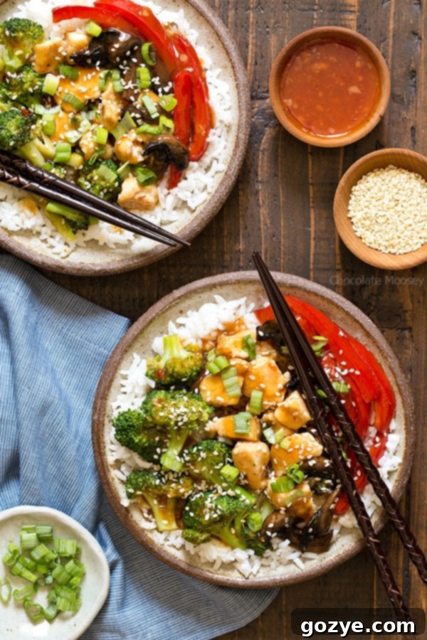 Spicy General Tsos Chicken Bowl 2 A cheaper and healthier alternative to Chinese takeout - homemade General Tso's Sweet Chili Chicken Rice Bowls with broccoli, red bell pepper, and mushrooms.