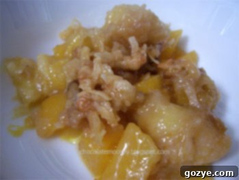 A close-up shot of a baked tropical crumble topped with streusel, golden brown and inviting.