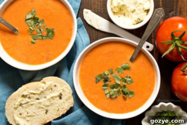 A close-up of creamy homemade tomato soup, showing its smooth texture and appetizing color.