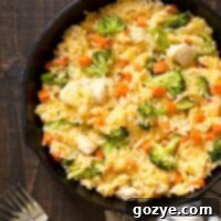 Close up of cheesy chicken broccoli rice in cast iron skillet