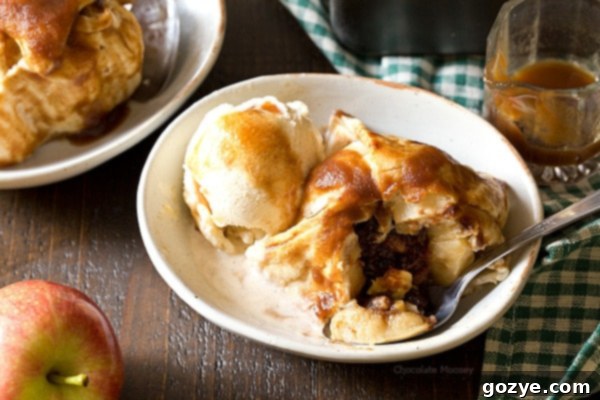 A batch of baked Apple Butter Dumplings, golden brown and glistening with syrup.