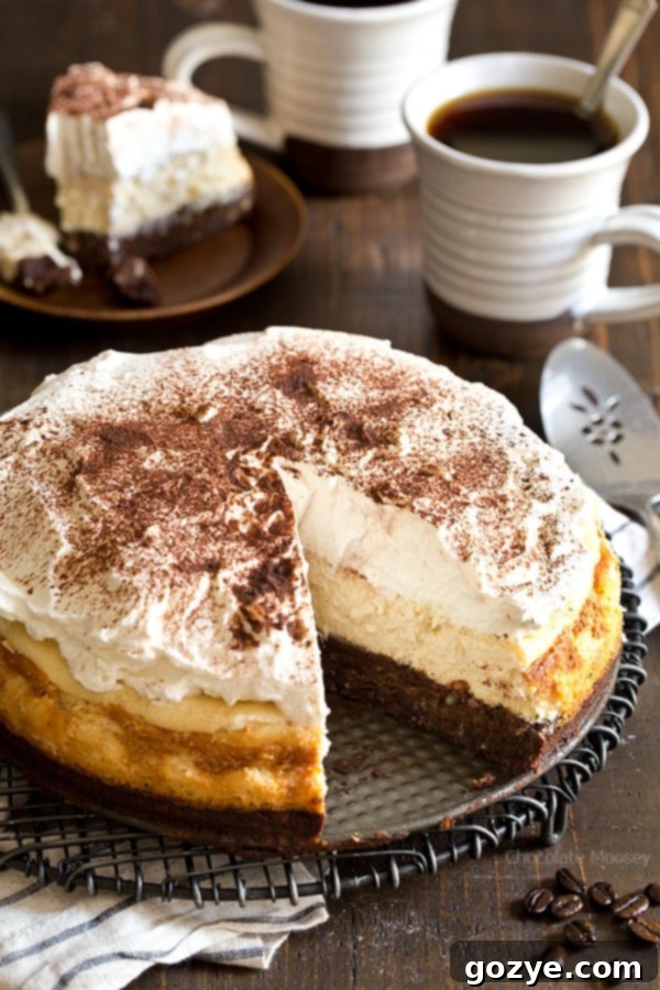 Decadent Mocha Brownie Cheesecake with a thick layer of coffee whipped cream, perfect for coffee lovers.