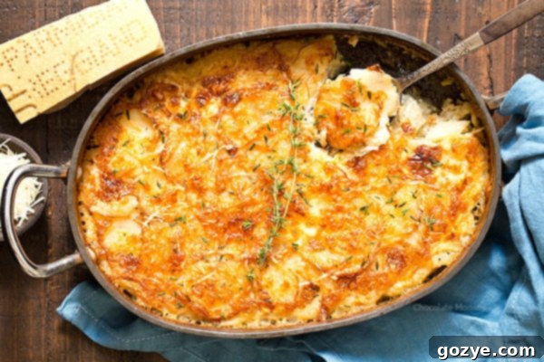 Garlic Parmesan Au Gratin Potatoes in casserole dish with spoon