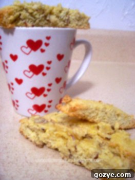 Close-up of golden Lenox Biscotti slices arranged beautifully on a plate, ready to be enjoyed with a hot beverage.
