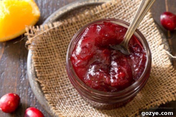 Fresh-Made Small Batch Cranberry Sauce 4 Easy homemade cranberry sauce in a small jar with a spoon