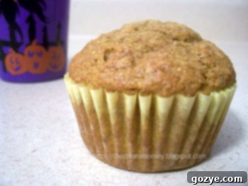 A close-up shot of baked pumpkin muffins, showcasing their golden-brown tops and inviting texture.