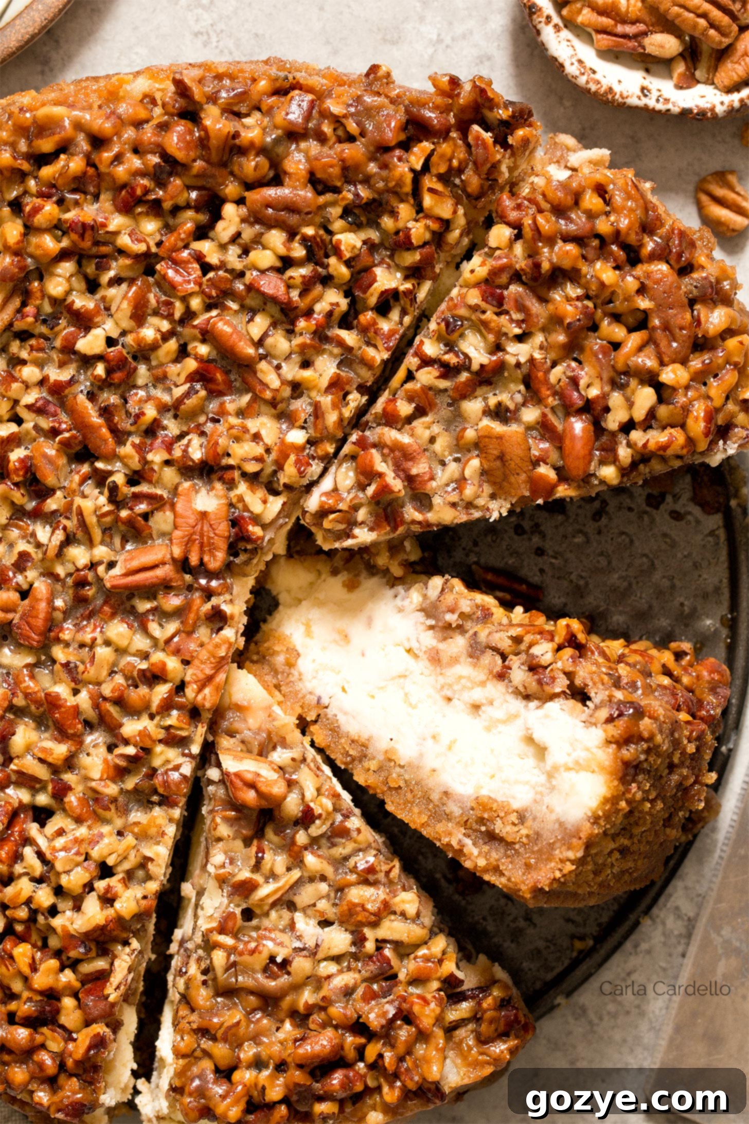 Ultimate Pecan Pie Cheesecake 2 Close up shot of pecan pie cheesecake slice