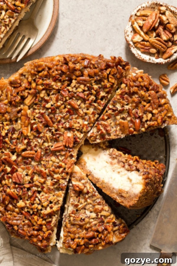 Ultimate Pecan Pie Cheesecake 3 Pecan Pie Cheesecake cut into slices with one slice on its side