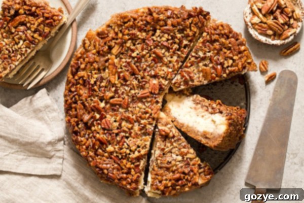 Ultimate Pecan Pie Cheesecake 4 Pecan Pie Cheesecake cut into slices with one slice on its side