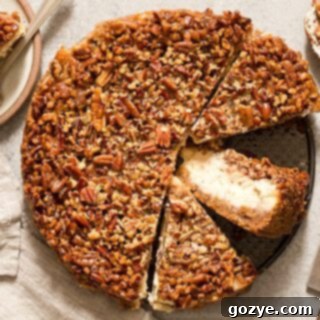 Ultimate Pecan Pie Cheesecake 6 Pecan Pie Cheesecake cut into slices with one slice on its side