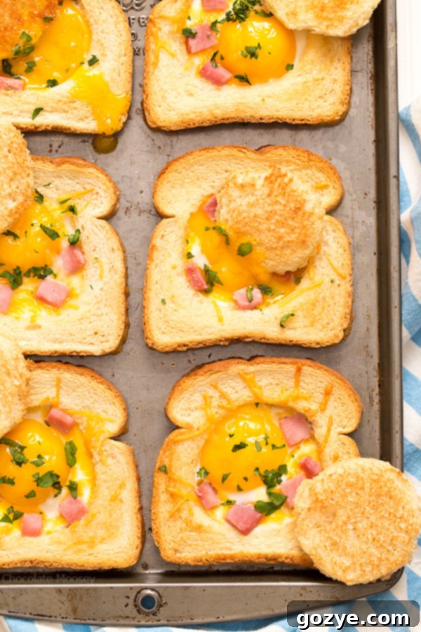 Close up of baked eggs in toast with ham and cheese