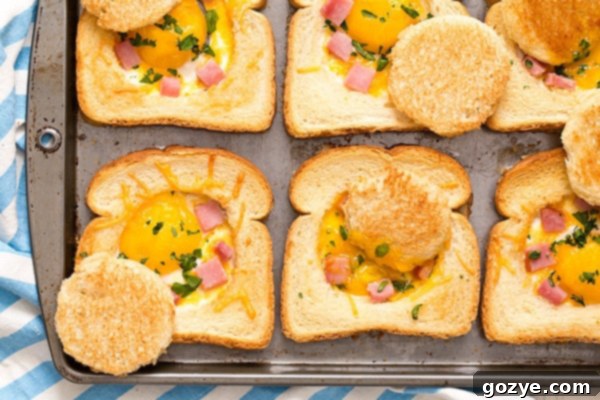 Close up of baked eggs in toast with ham and cheese