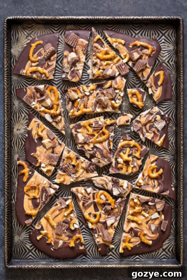 Broken up chocolate peanut butter bark on a cookie tray