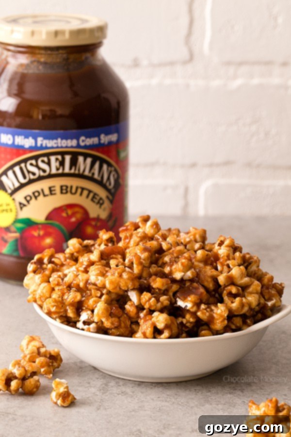 Irresistible Caramel Apple Butter Popcorn on a baking sheet, glistening with sweet and spiced caramel.