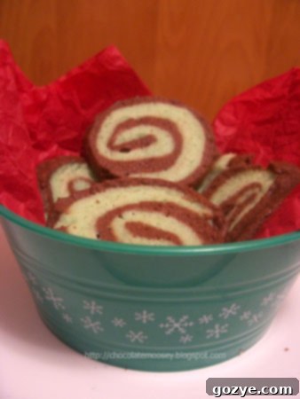 Beautifully swirled Chocolate Mint Pinwheel Cookies on a baking rack, showcasing the intricate design of the mint green and chocolate dough.