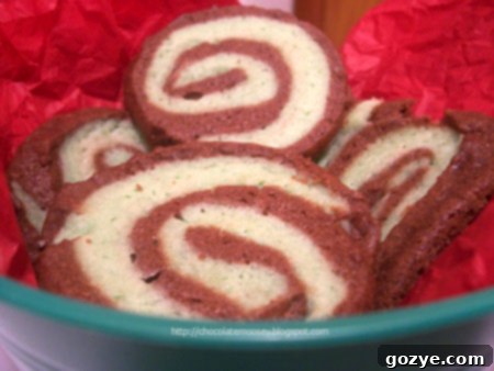 Close-up of freshly baked Chocolate Mint Pinwheel Cookies, showing the distinct green and brown layers.