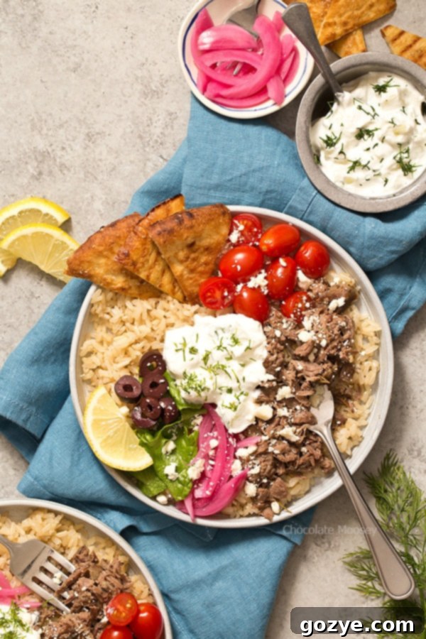 Delicious Slow Cooker Gyro Rice Bowls with tender lamb and fresh toppings, served with homemade tzatziki. Recipe makes 4 servings.