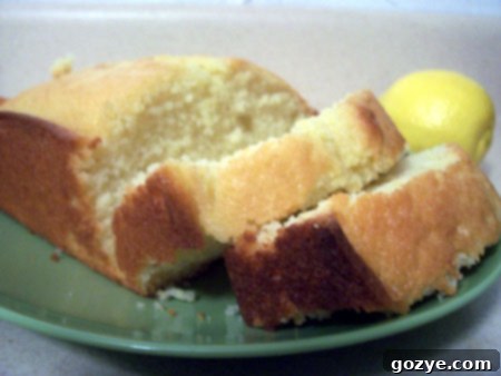 A close-up of the French Yogurt Cake, showing a golden crust and a gently sliced portion, ready for enjoyment.