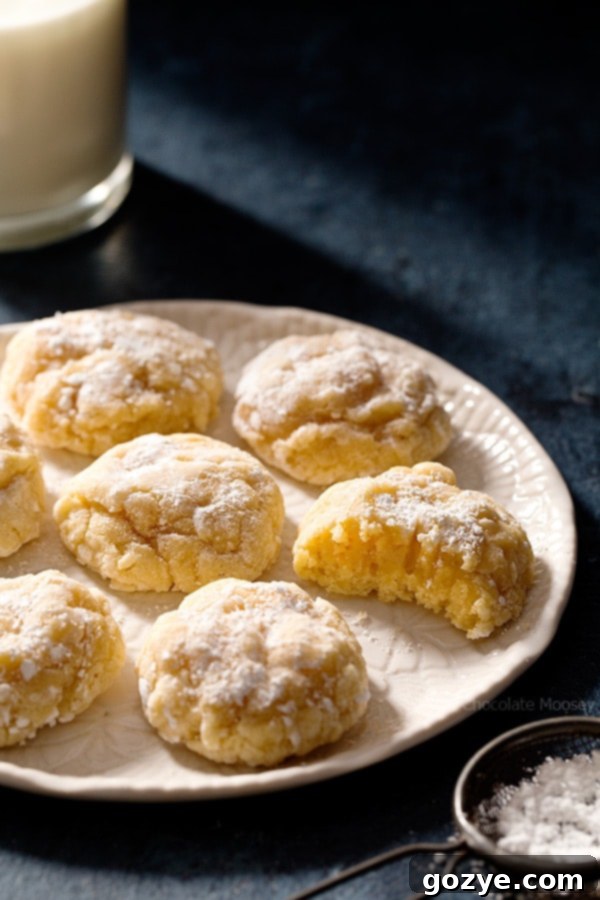Homemade Peanut Butter Gooey Butter Cookies 3 Peanut Butter Gooey Butter Cookies cooling on a rack, showcasing their soft, cracked tops and gooey texture.