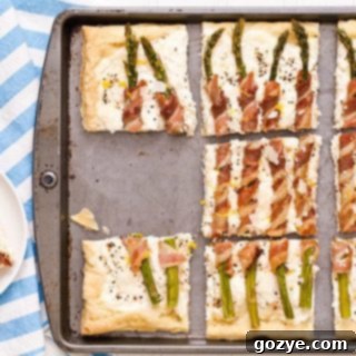 Flaky Asparagus and Bacon Puff Tart 7 Delicious Bacon Wrapped Asparagus Puff Pastry Tart with a golden crust.
