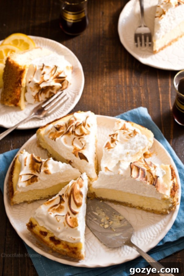 Lemon Meringue Cheesecake with meringue topping, still in its springform pan, ready for oven toasting.