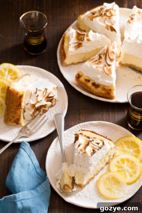 Close-up of a beautifully toasted Lemon Meringue Cheesecake, showing the golden peaks of the meringue.