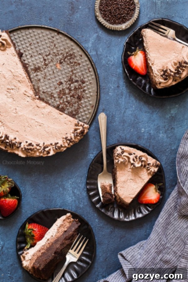 Plated slices of Brownie Bottom Chocolate Mousse Cake with chocolate whipped cream