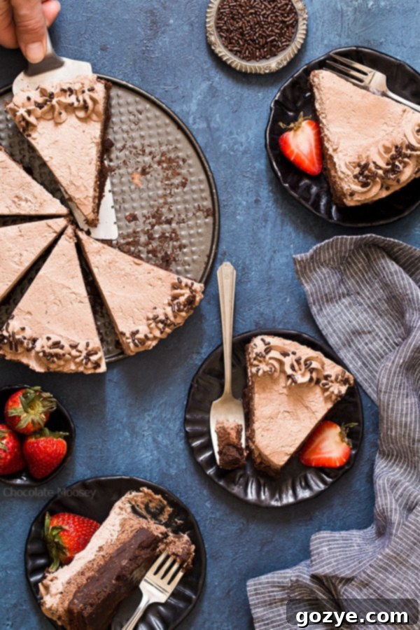 Serving slices of Brownie Bottom Chocolate Mousse Cake with chocolate whipped cream