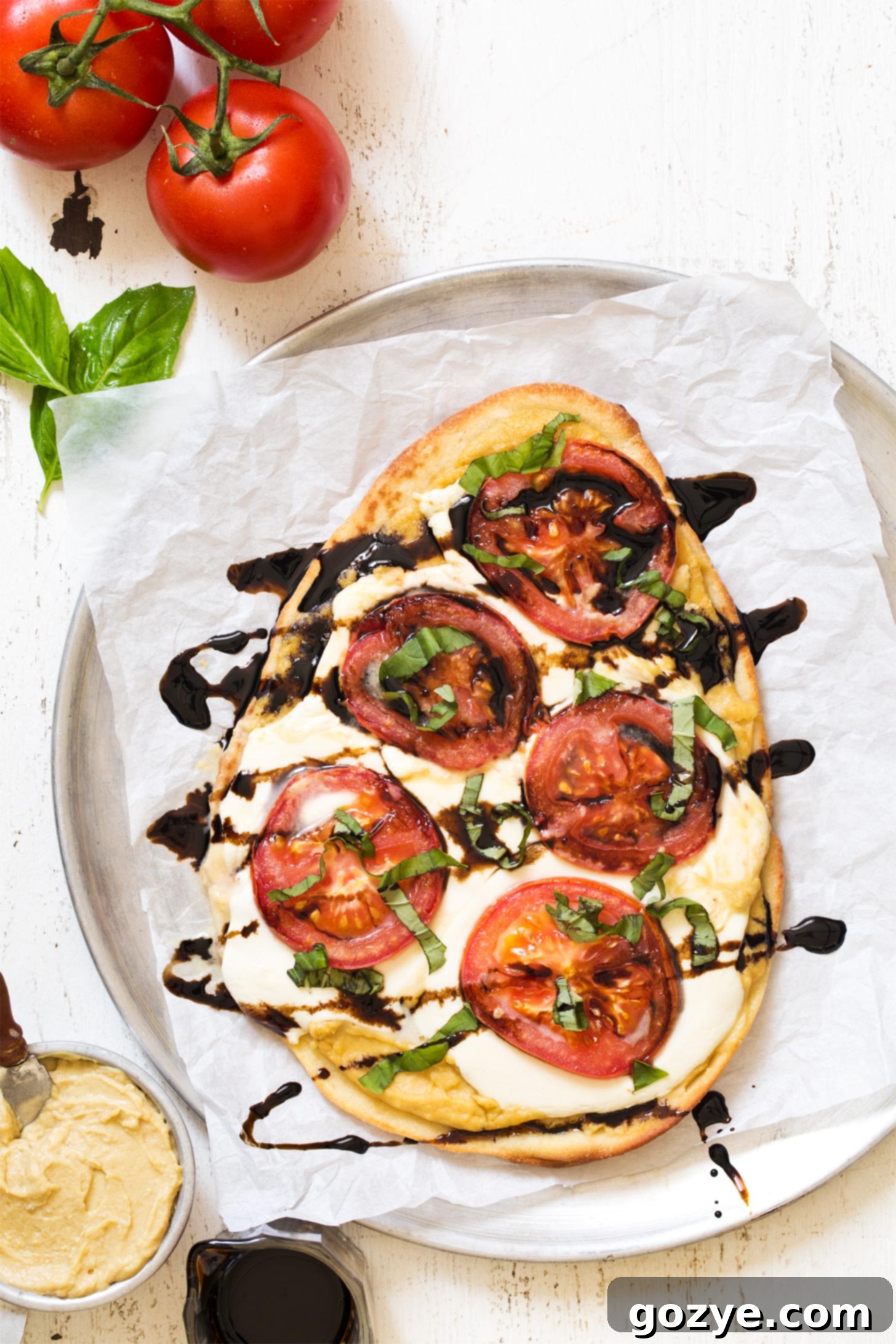 Whole hummus pizza uncut