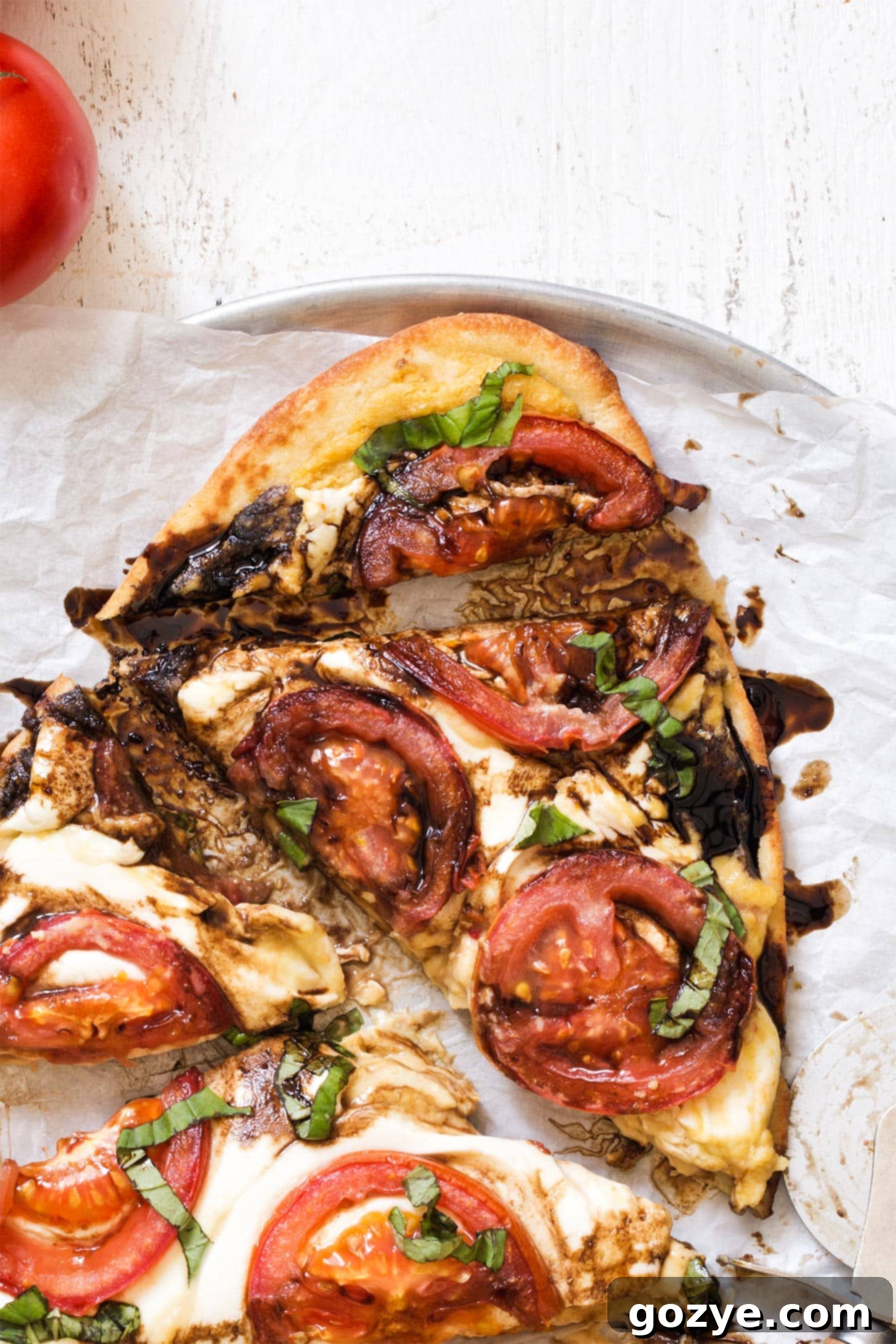 Close up of caprese pizza with hummus