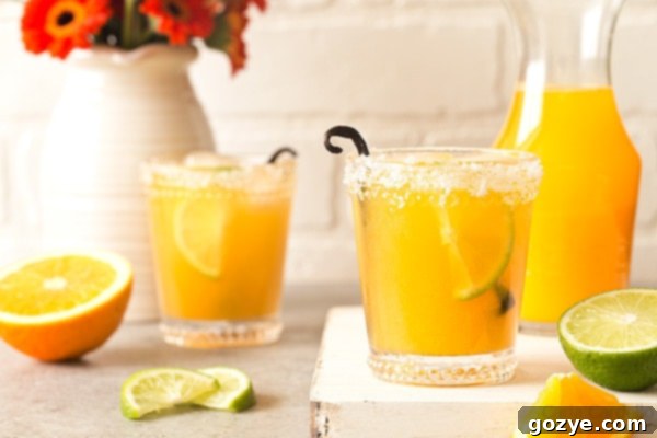 Orange Vanilla Margaritas are made with fresh orange juice, lime juice, and vanilla bean. Recipe makes two drinks.