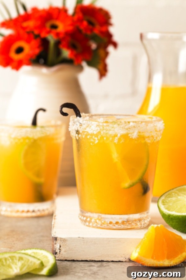 Orange Vanilla Margaritas are made with fresh orange juice, lime juice, and vanilla bean. Recipe makes two drinks.