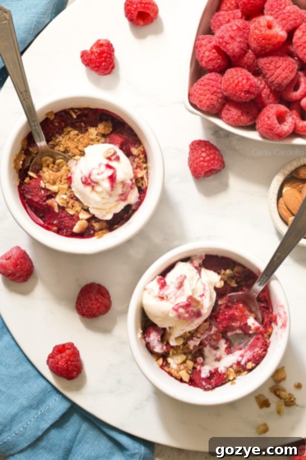 Raspberry Crisp Duet 5 mini Raspberry Almond Crisp For Two with a sweet and slightly tart raspberry filling topped with a crispy almond streusel baked in two ramekins.