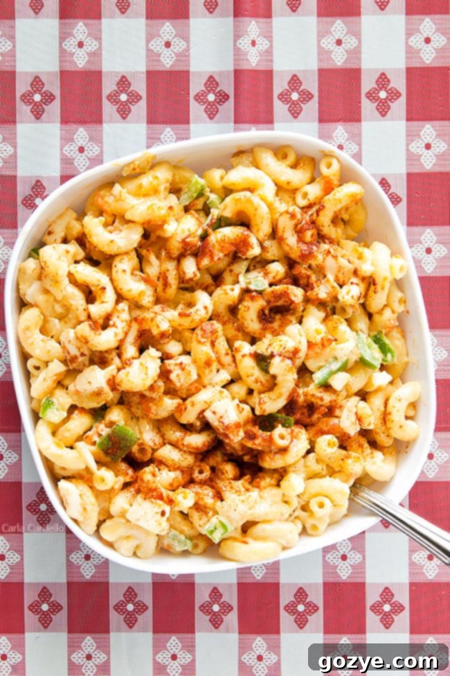 Amish Macaroni Salad in white bowl on red checkered background