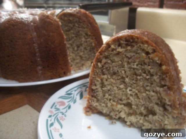 Moist Banana Bundt Cake Slice A perfectly sliced piece of moist Dorie's Classic Banana Bundt Cake on a plate.