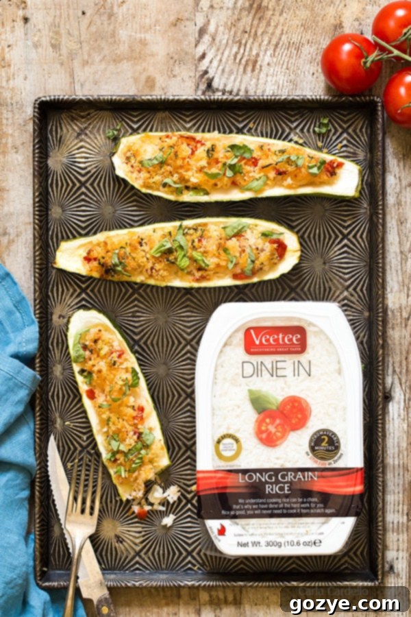Garlic Parmesan Stuffed Zucchini Boats stuffed with rice, tomatoes, cheese, and basil