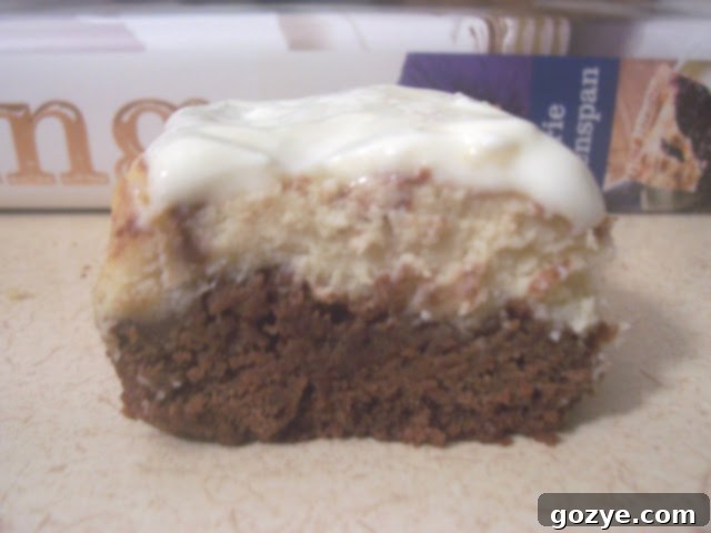 A close-up of a cut Espresso Cheesecake Brownie, revealing the rich chocolate and cheesecake layers.